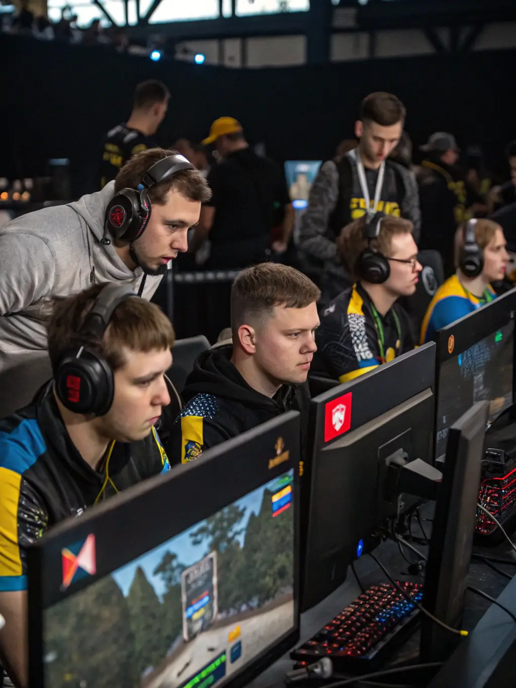 A professional image featuring THE DICE esports team wearing their official jerseys, posing confidently in a gaming arena before a tournament.